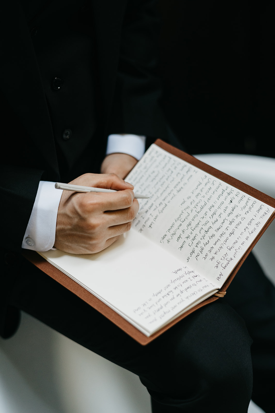 Groom writing his vows before ceremony