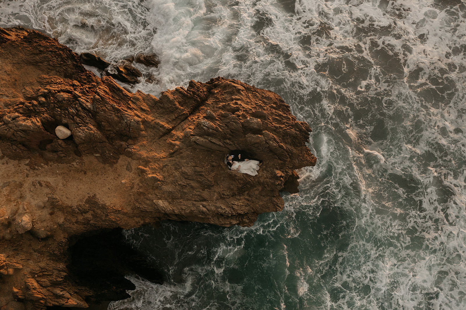 Drone photo of bride and groom on cliffs of Big Sur California.