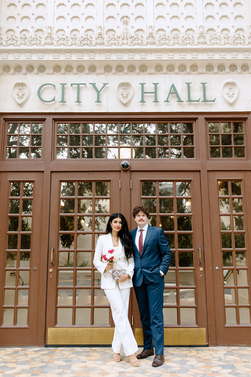 Bride and groom in front of city hall doors