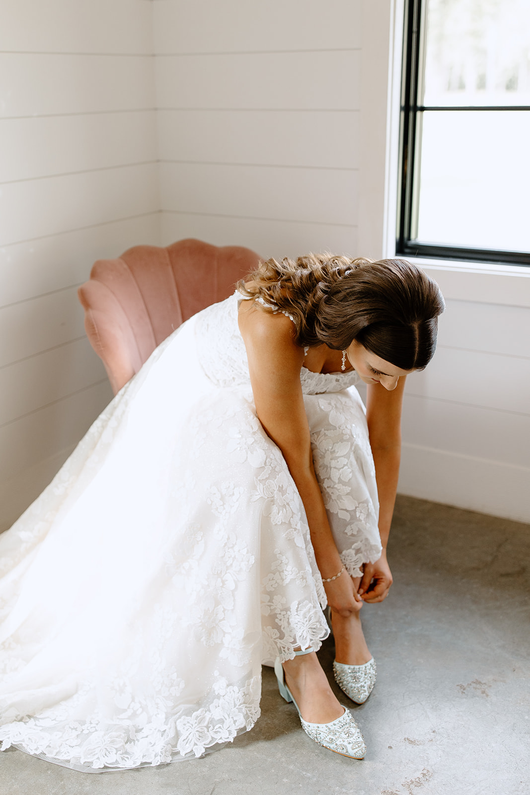 Bride putting her shoes on