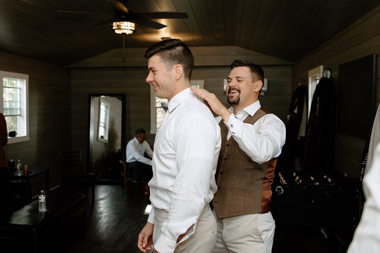 Groom helping his brother get ready