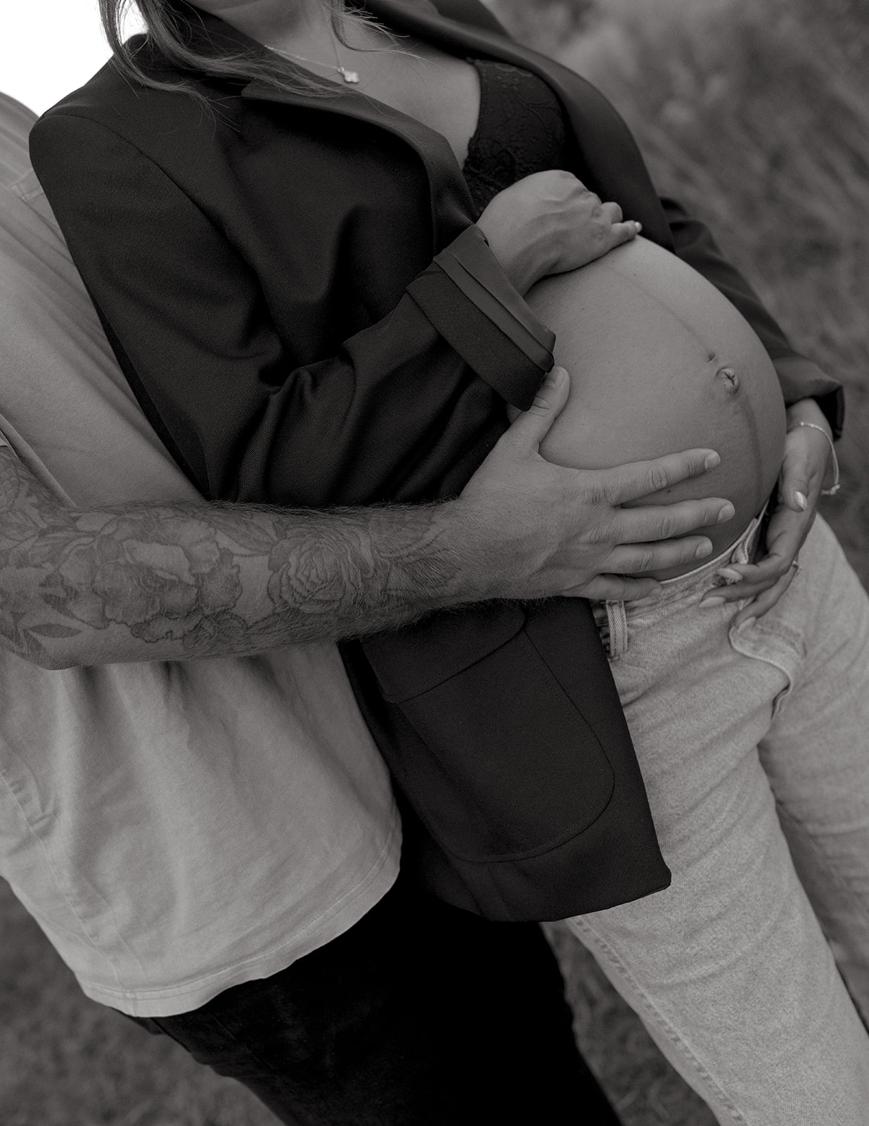 Dad holds mom's belly during maternity session