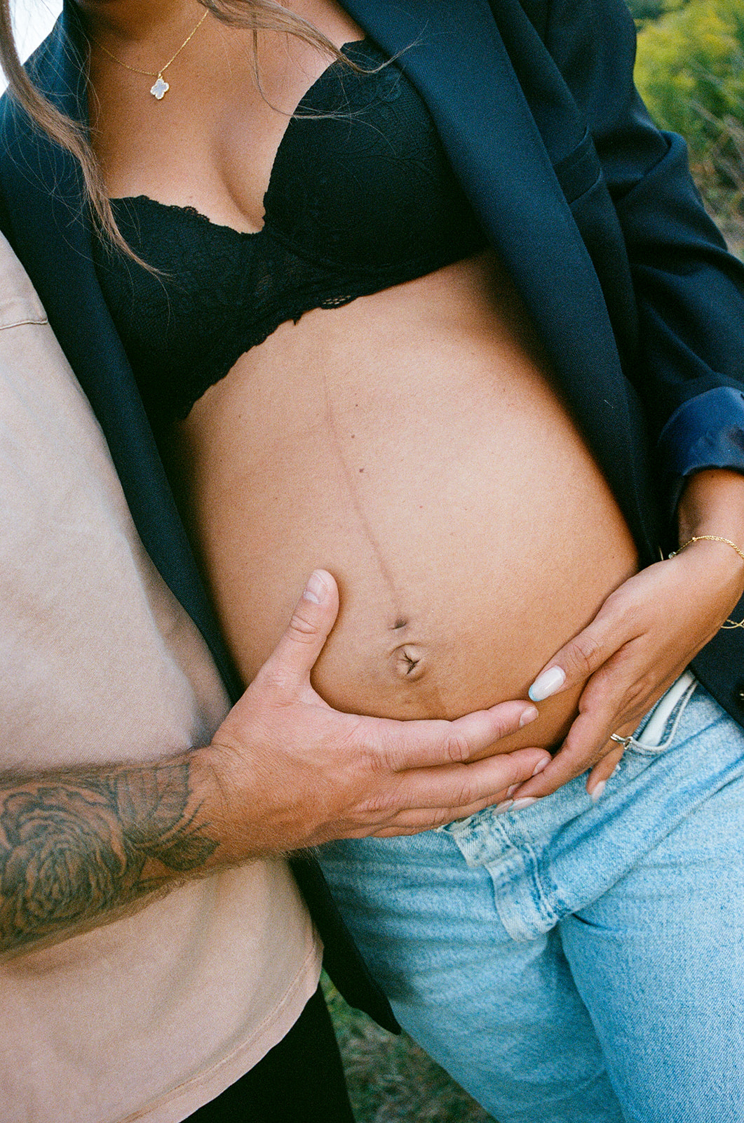 Dad holds mom's belly for a film photo during their maternity session