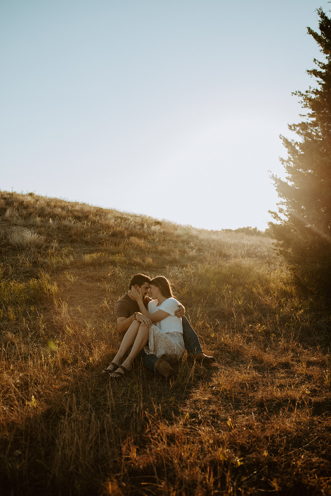 A candid photo of a couple in a field in Dallas at Golden Hour