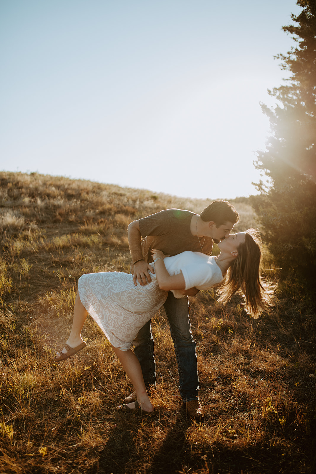 A couple in Dallas Texas kissing during their engagement session at golden hour