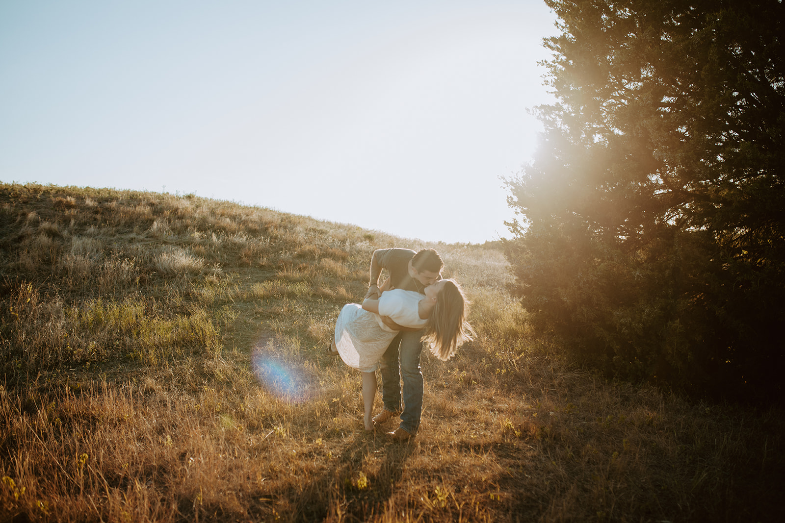 A couple session at Arbor Hills Nature Preserve kissing at golden hour.