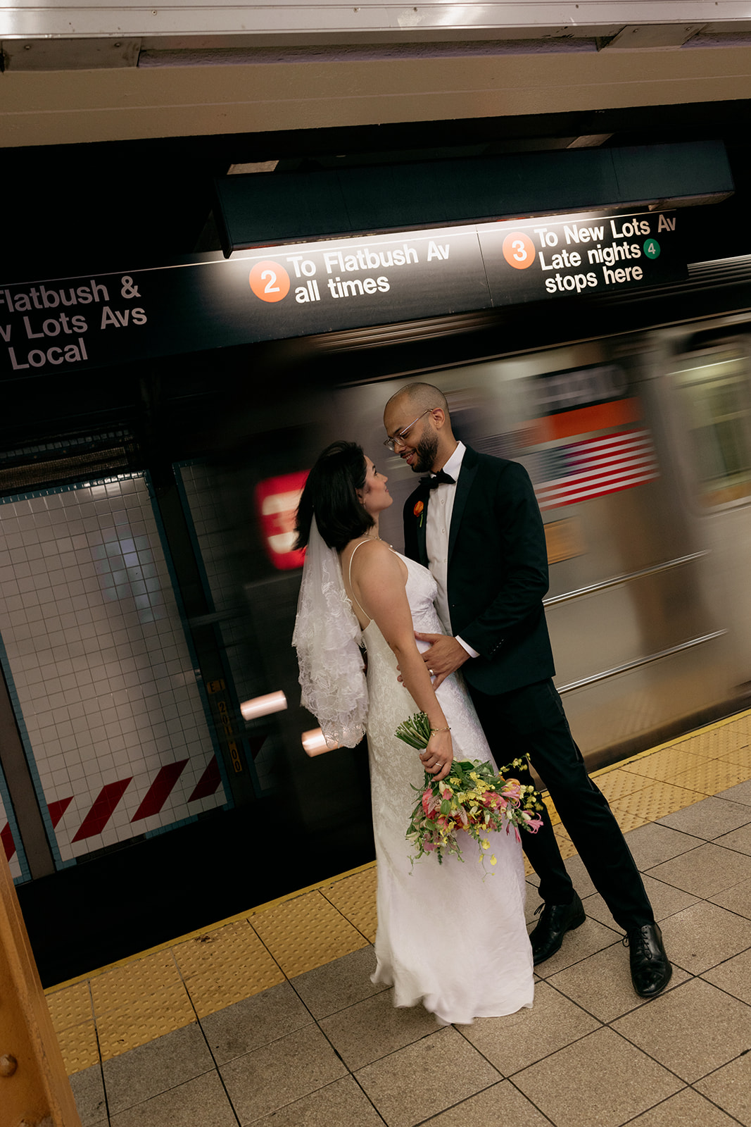 A couple eloping in Brooklyn taking the subway together