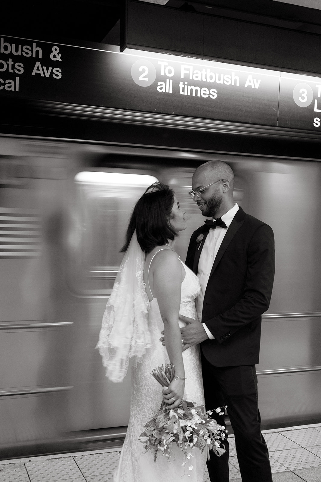 A couple eloping in Brooklyn taking the subway together