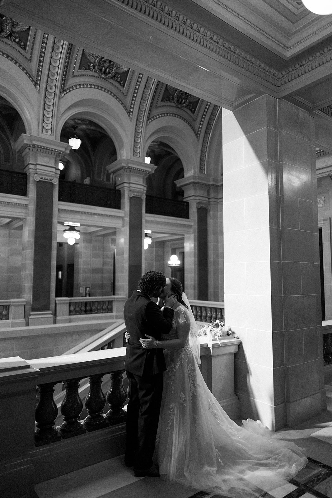 bride and groom get close during portraits at the wisconsin state capitol during their fall elopement in madison