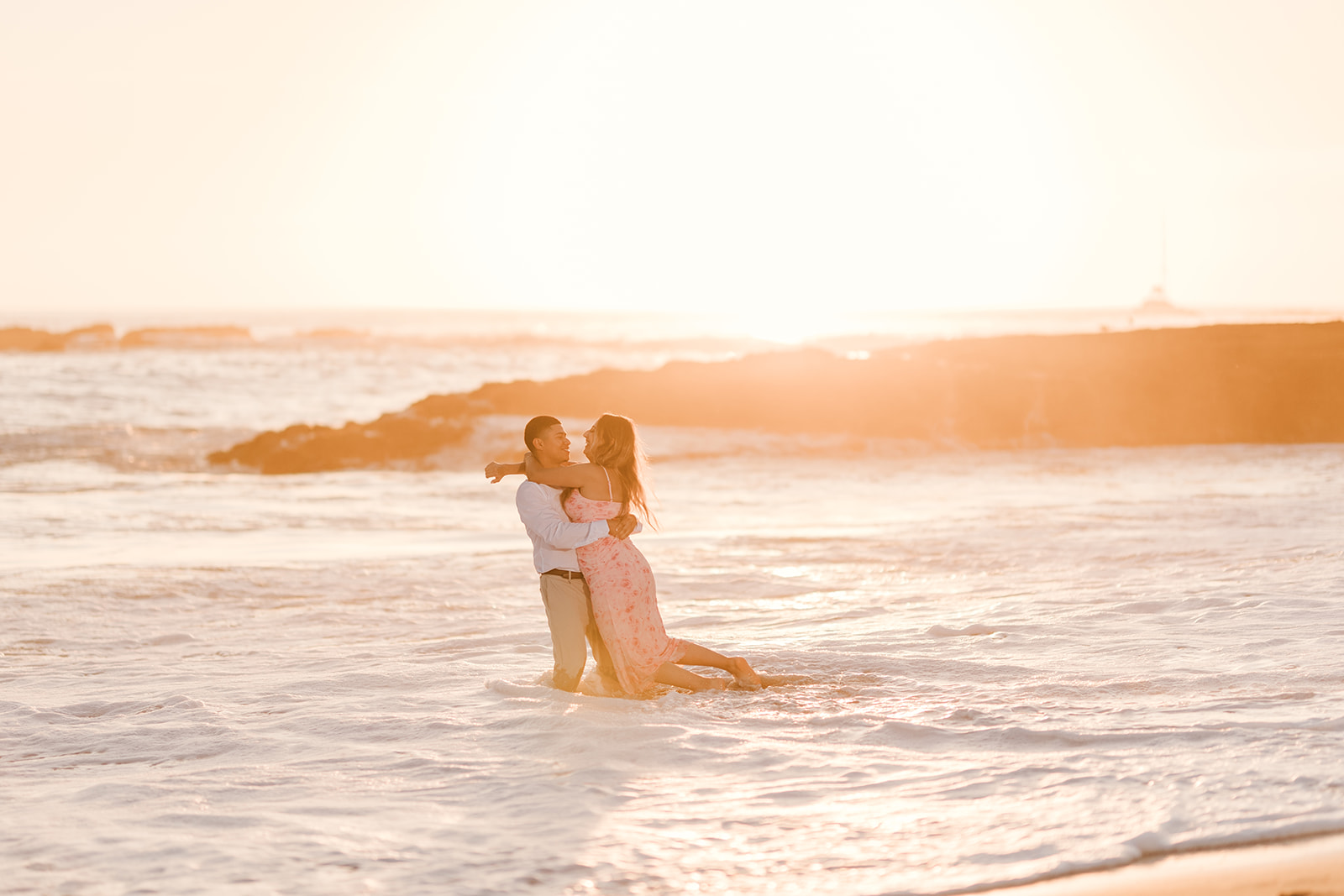 Engaged couple in the beach waves