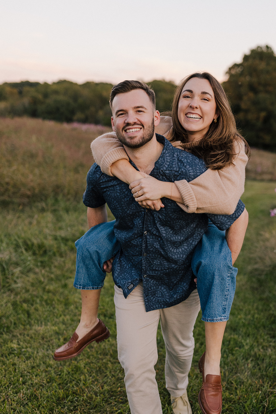Raleigh Engagement Photographer NCMA riding piggyback in the meadow