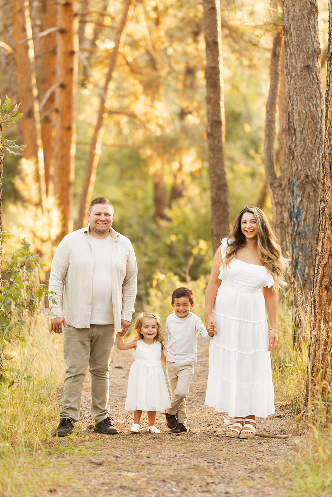 neutral outfits for fall family photos in castle rock colorado with pine trees and forest 80108