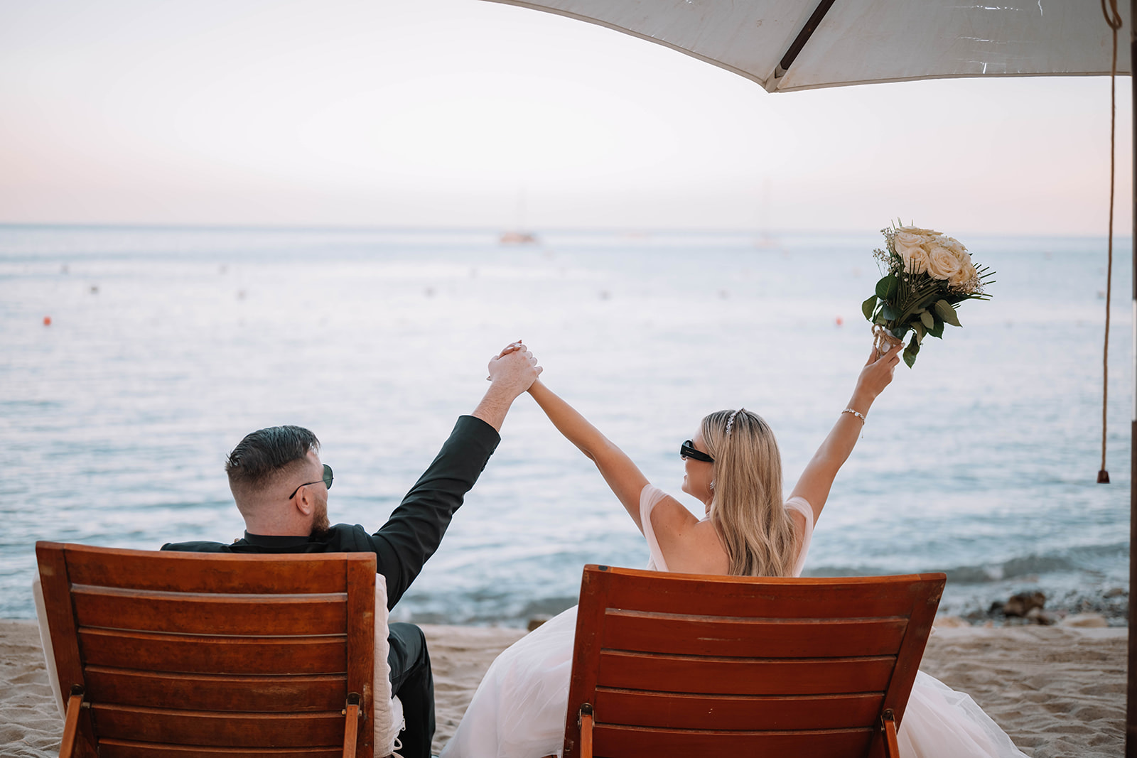 couple who eloped to catalina island share a fun moment at the Descanso beach club