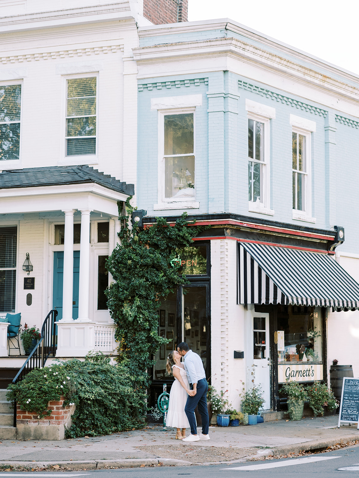 A couple's engagement photo in front of Garnetts Sandwich Shop in Richmond Virginia showing the entire building