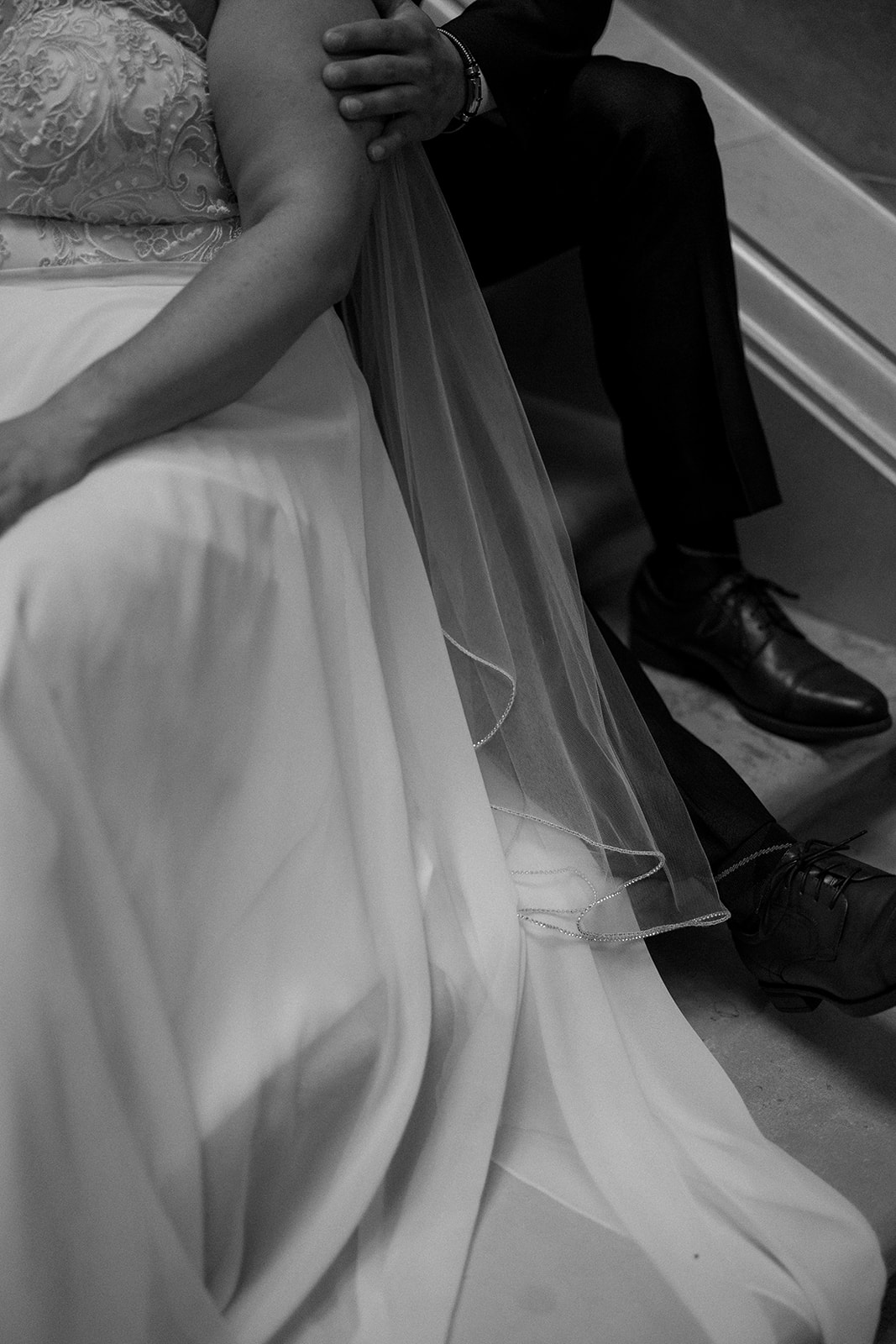 bride and groom embrace in capitol building during their intimate elopement day