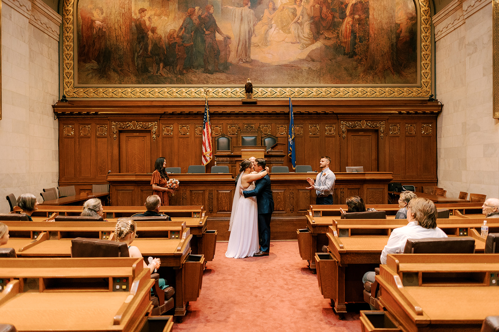 bride and groom kiss in capitol building during their ceremony on their intimate elopement day 
