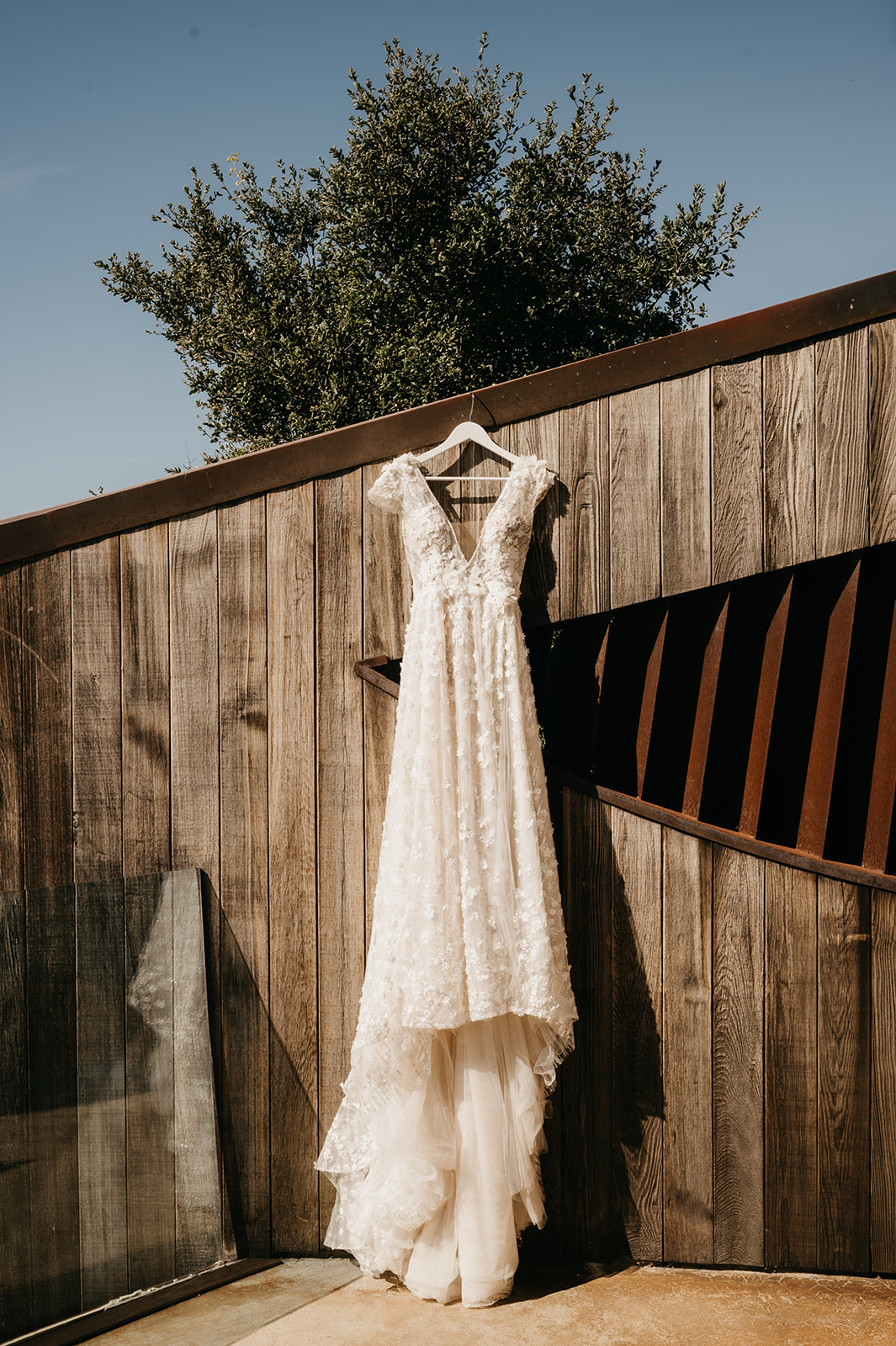 Bridal Dress hanging on wooden wall Post Ranch