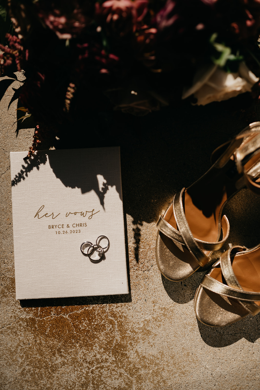 Bridal heels, vow books, and wedding rings with bridal bouquet