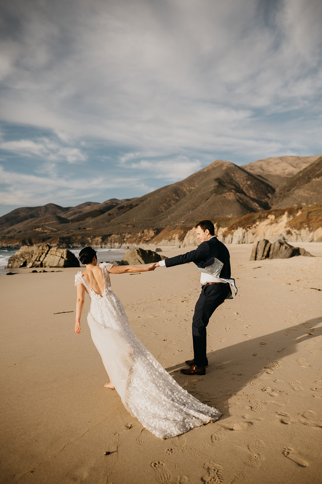 Bride and groom dancing on the beach after ceremony in Big Sur, California