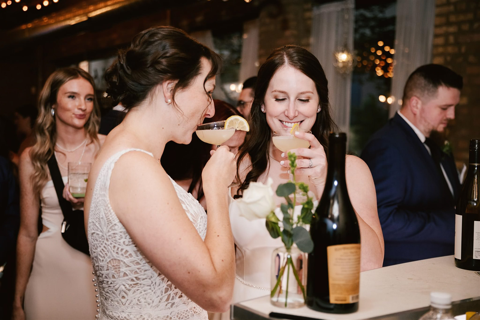 A same-sex couple sharing a toast at their wedding at Loft on Lake, capturing a moment of love and celebration.