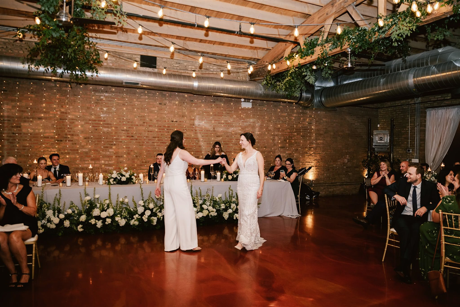 Two brides sharing their first dance at Loft on Lake, showcasing a moment of love and celebration.