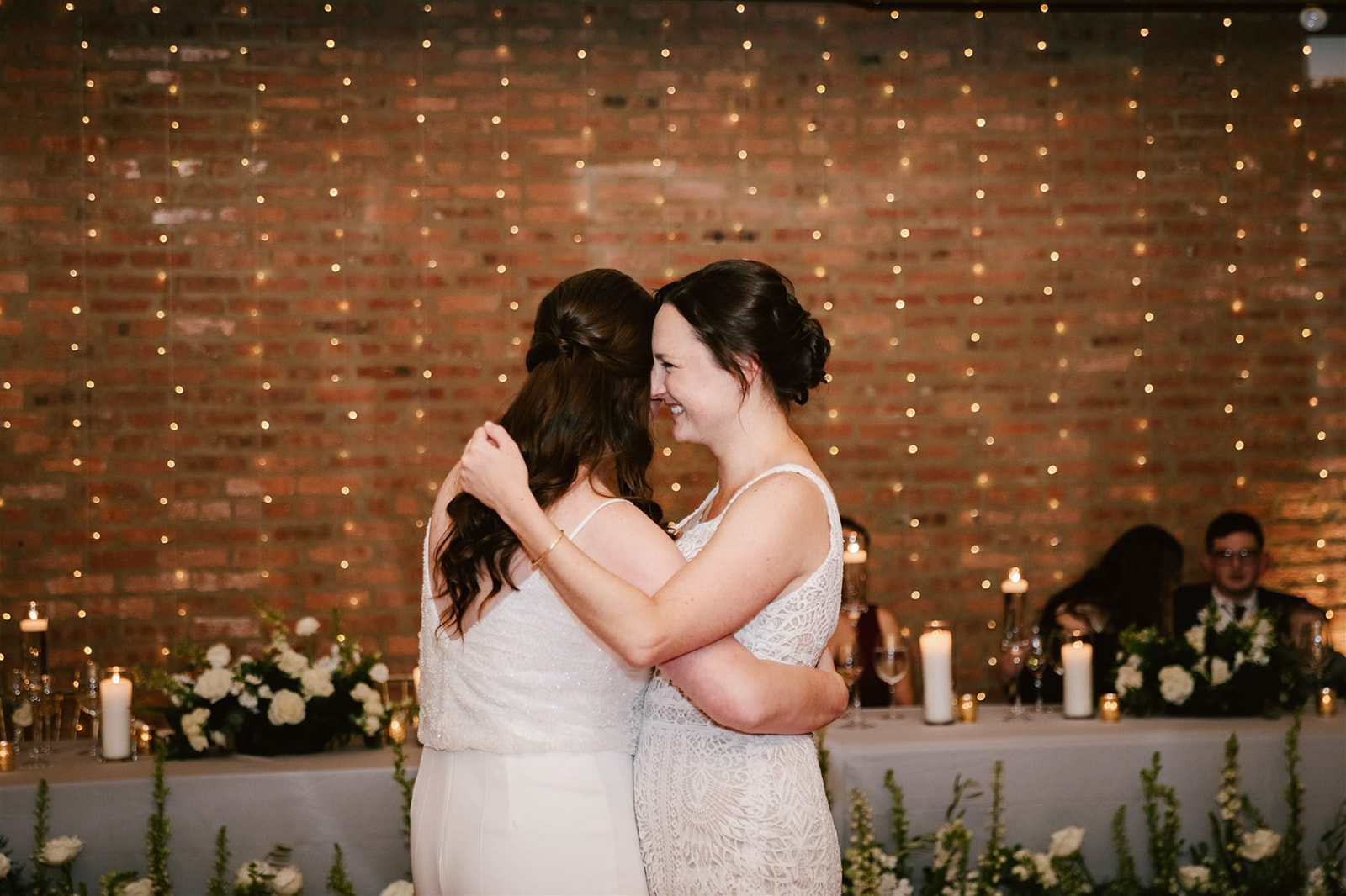 Two brides sharing their first dance at Loft on Lake, showcasing a moment of love and celebration.
