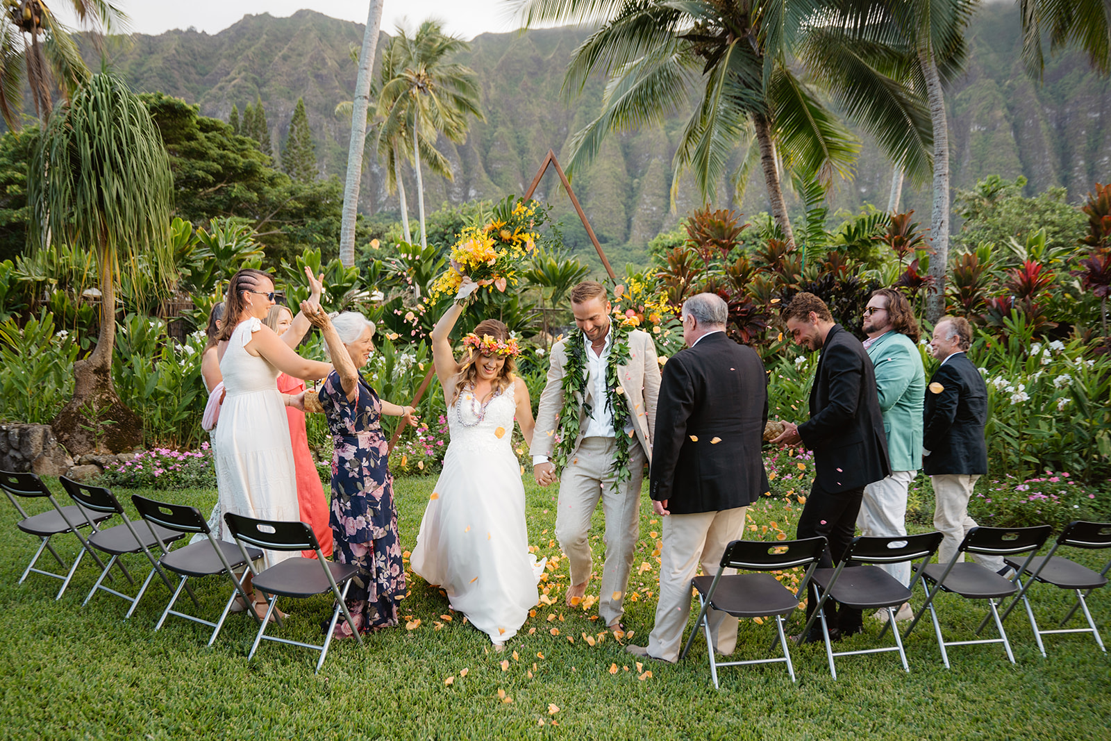 Petals are thrown as a couple walks down the aisle after their oahu wedding ceremony at Open Palms Plantation venue