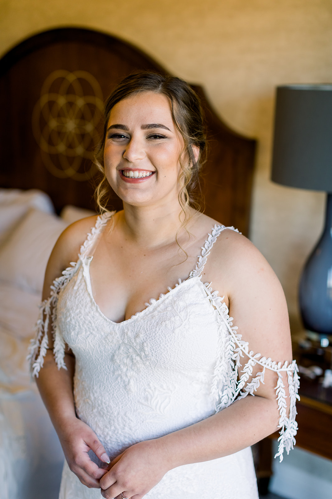 Bride smiles at camera in her wedding dress for her big day