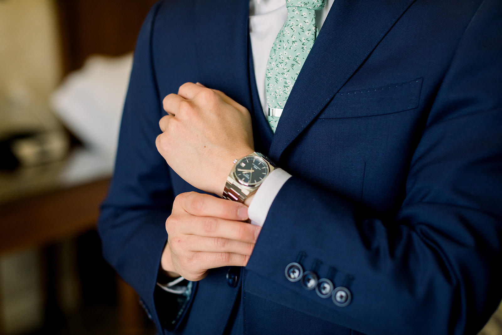 Groom adjusts his watch ready for his wedding at allegretto resort