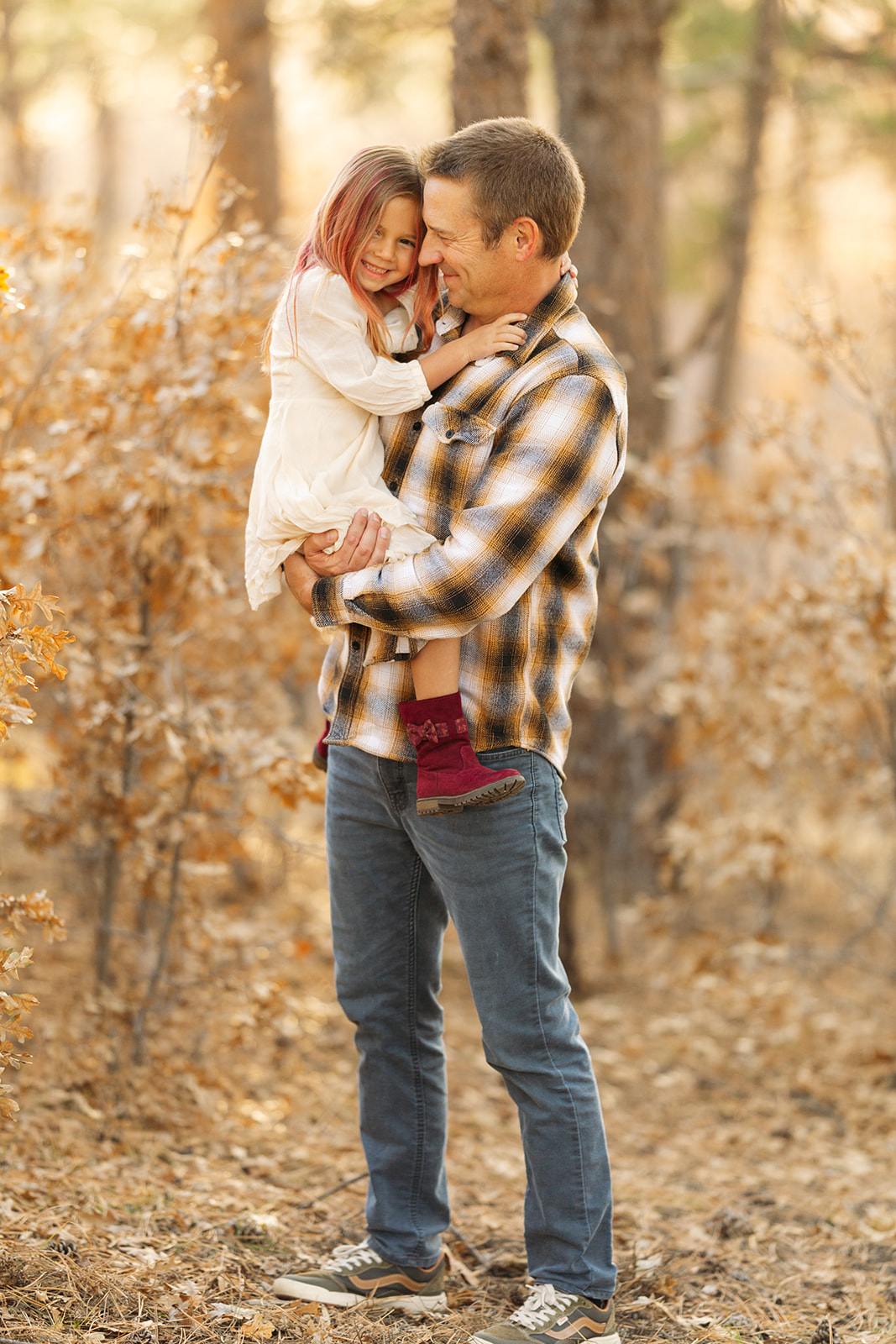 Colorado fall family photos, November in forest location with mountain background, neutral and natural outfit colors
