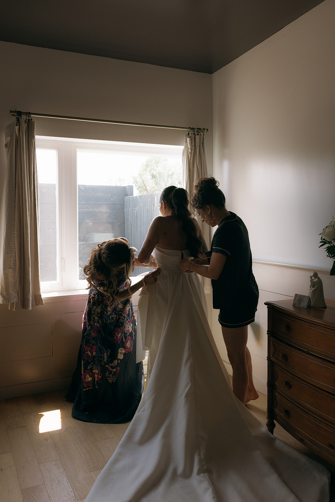 Bride puts on her wedding dress before wedding ceremony at Audrey's Farmhouse