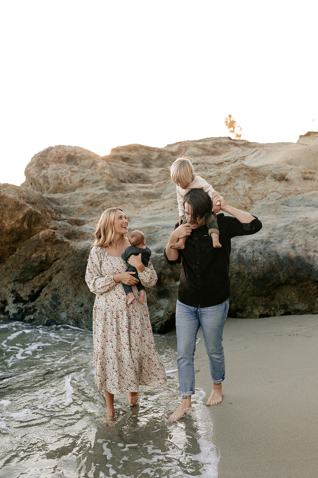 golden hour family laguna beach photoshoot california socal children playing in water parents hugging children maternity