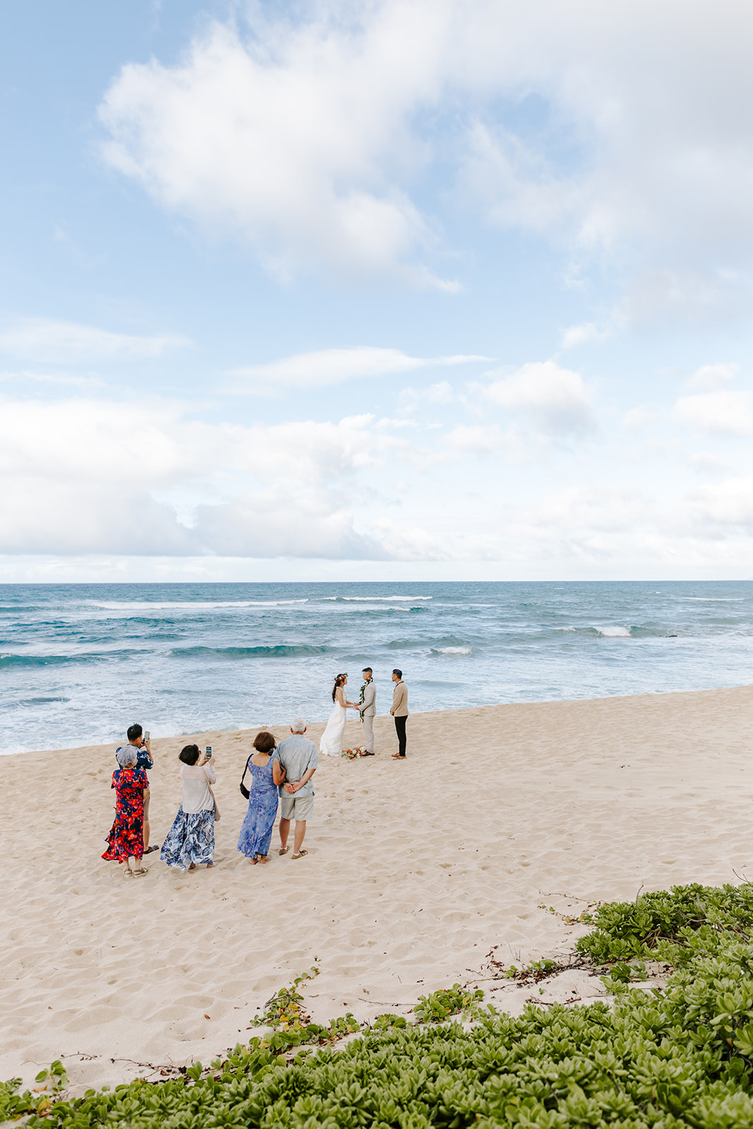 A couple who eloped on the North Shore of Oahu say their vows near Haleiwa on a secluded beach in Hawaii. 