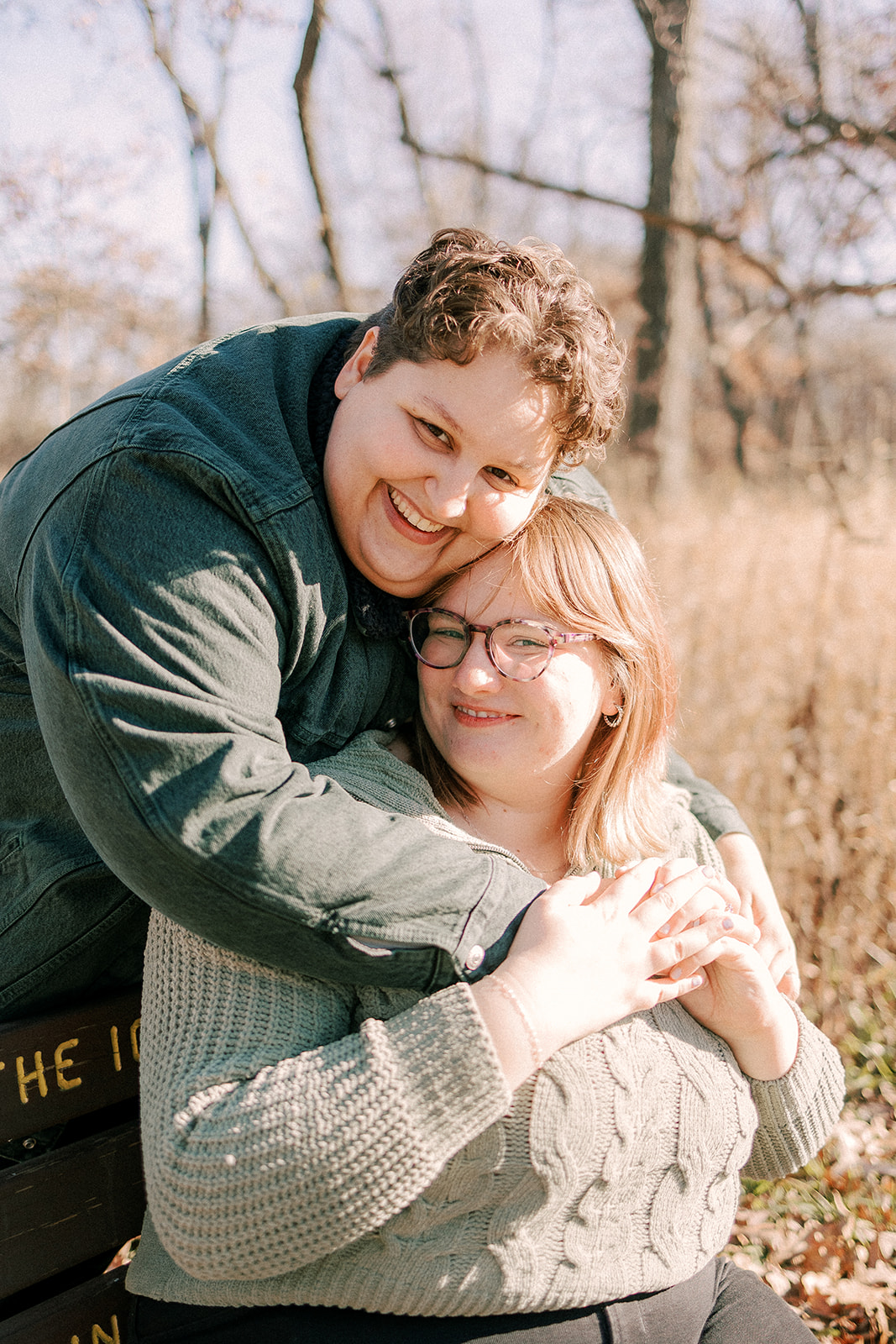 engaged couple smiles at the camera during their engagement photos in madison wisconsin