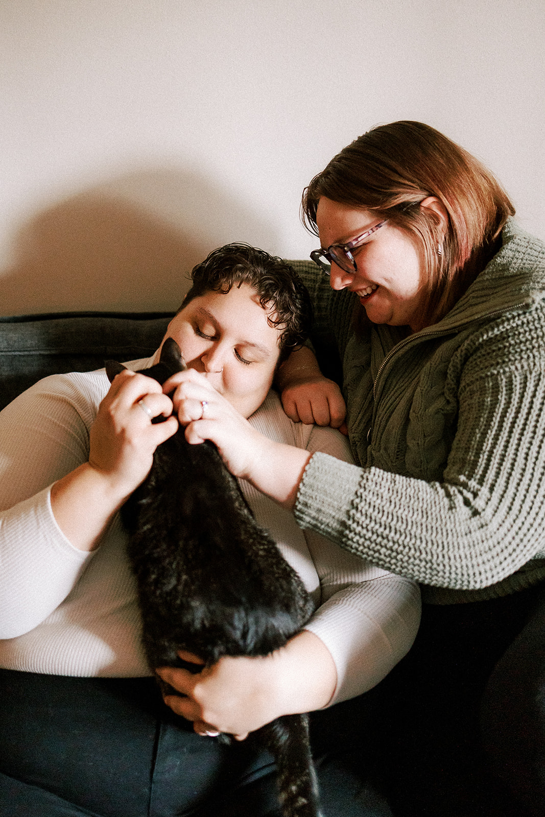lgbtq couple laughs at their home with their cats
