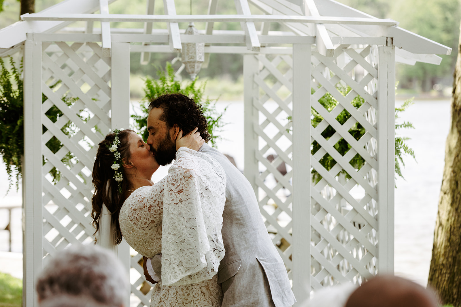 first kiss under a pergola at garden wedding Brianna Kirk Photography