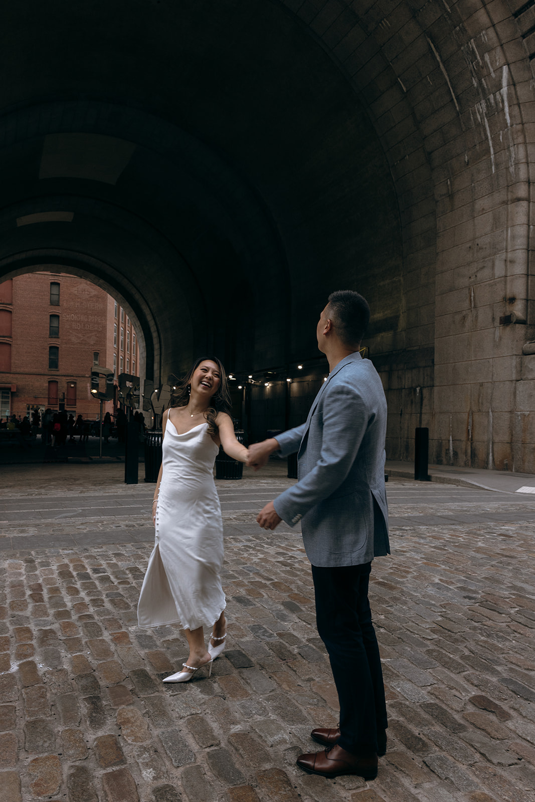 A couple dances in the cobble streets of DUMBO, Brooklyn