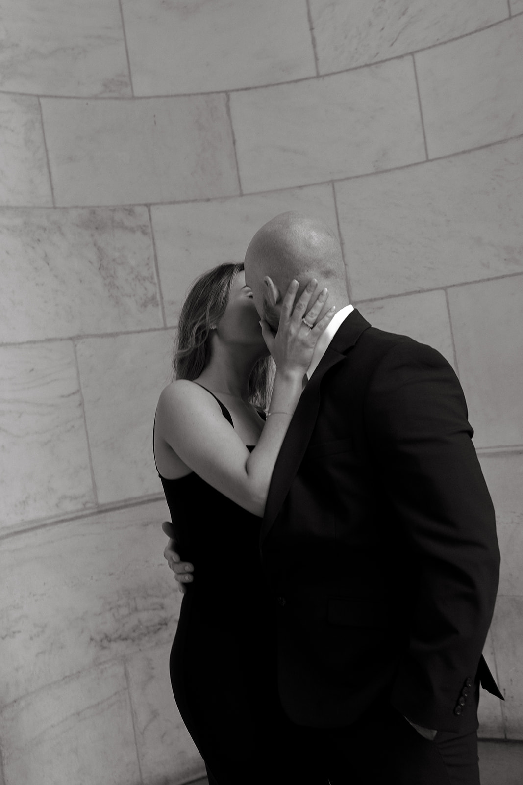 A couple kisses for their engagement session at the New York Public Library