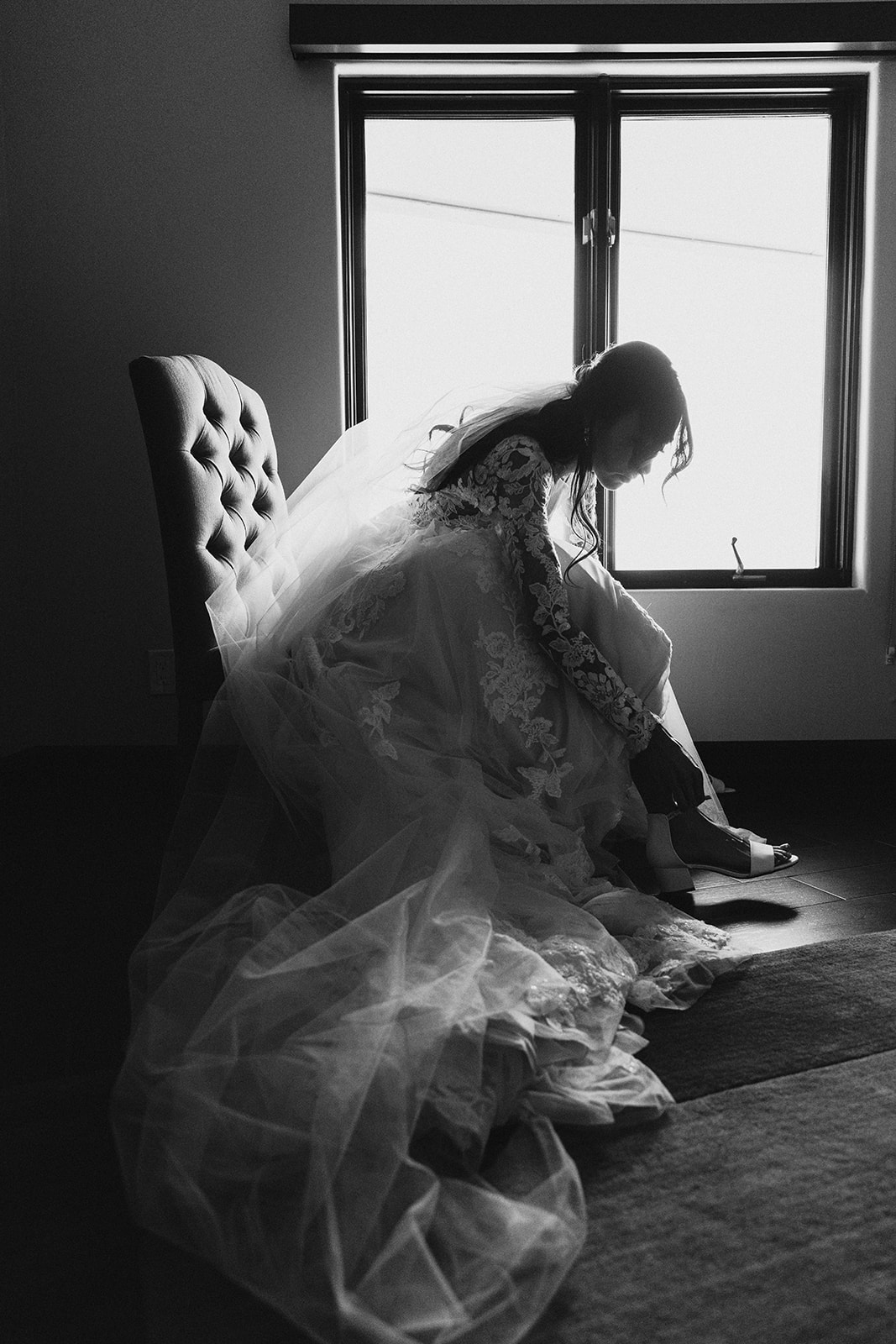 creative documentary black and white bridal portraits getting ready putting on shoes brianna kirk photography
