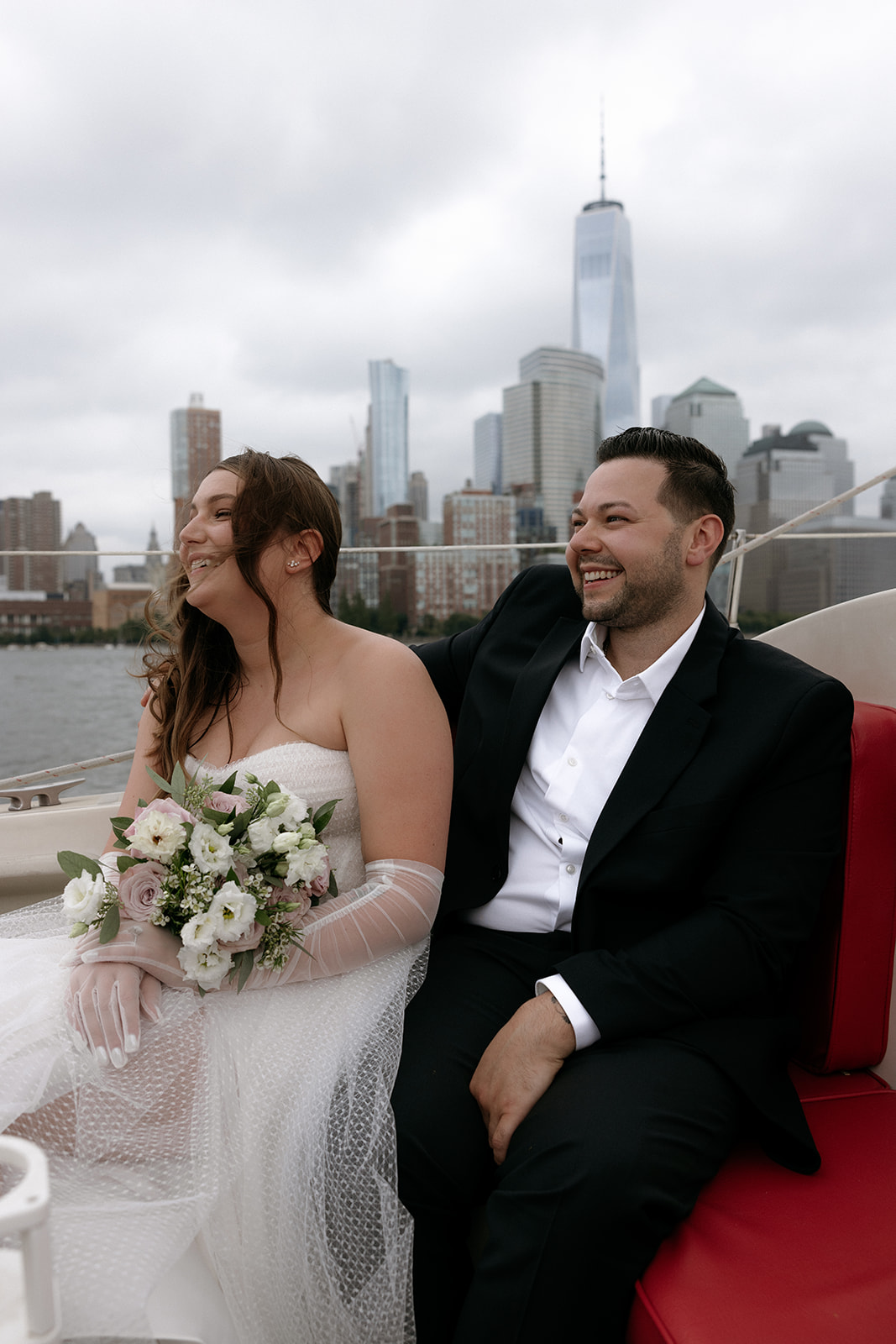 A couple sits on a boat as they wait to elope in NYC