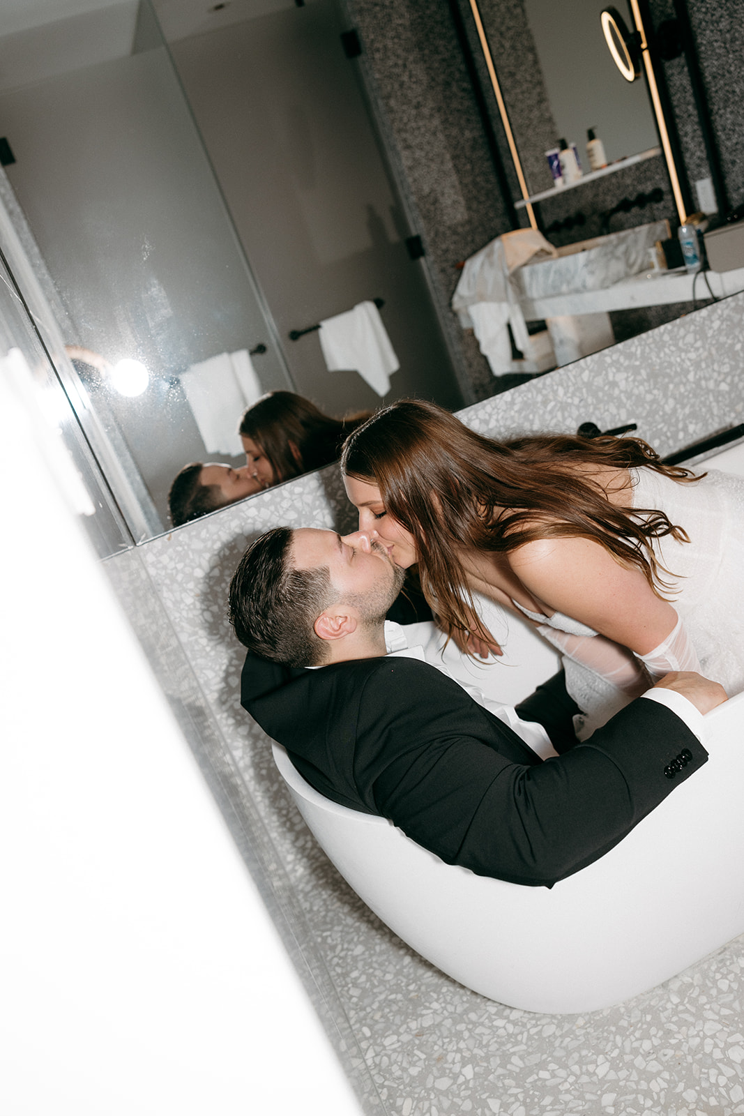 A couple who eloped in NYC sit in their hotel bathtub and kiss