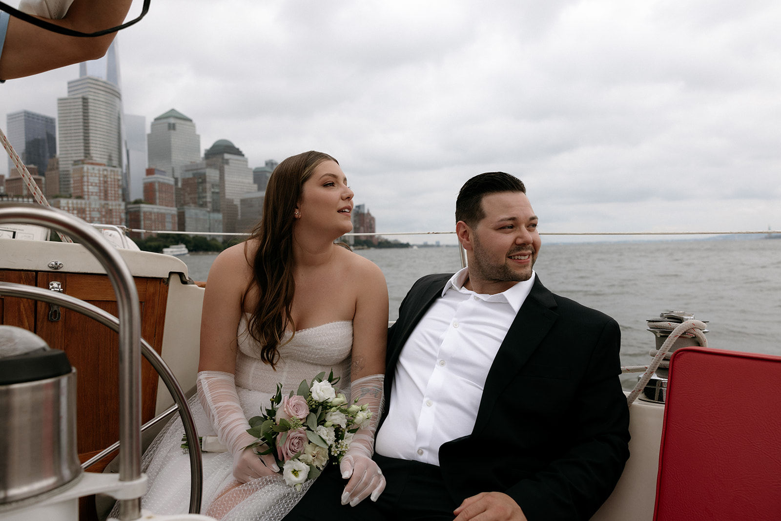 A couple sits on a boat as they wait to elope in NYC