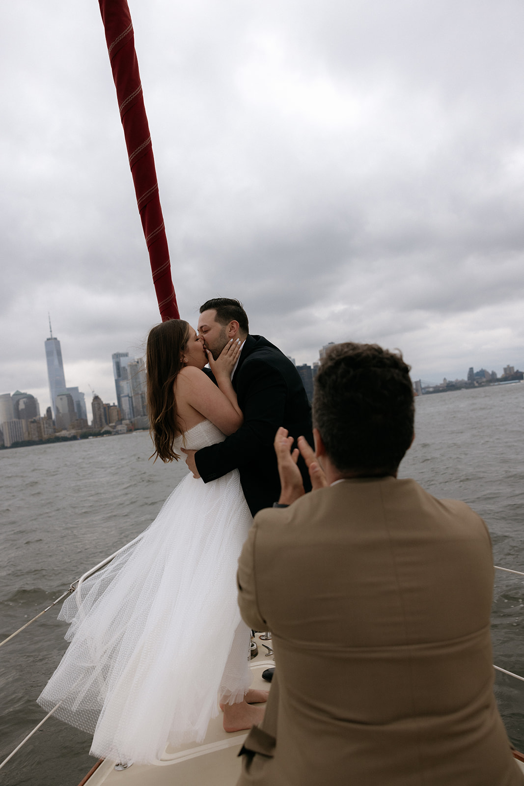 A couple who eloped on a NYC boat kiss as they become husband and wife