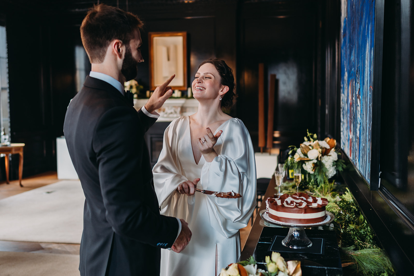 bride and groom share cake at Patterson Mansion Wedding in Washington DC