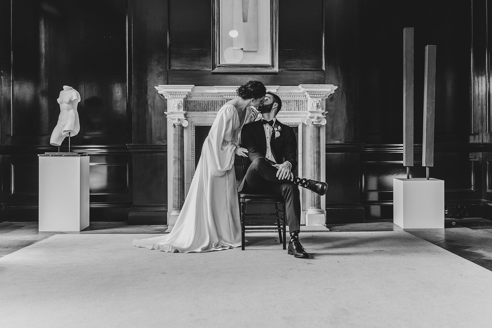 bride kisses groom seated at Patterson Mansion Wedding in Washington DC