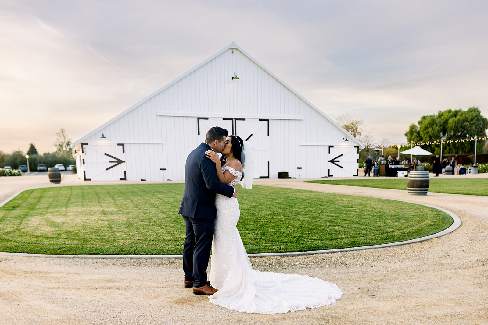 The White Barn's timeless appeal frames the couple as they exchange heartfelt vows, surrounded by loved ones