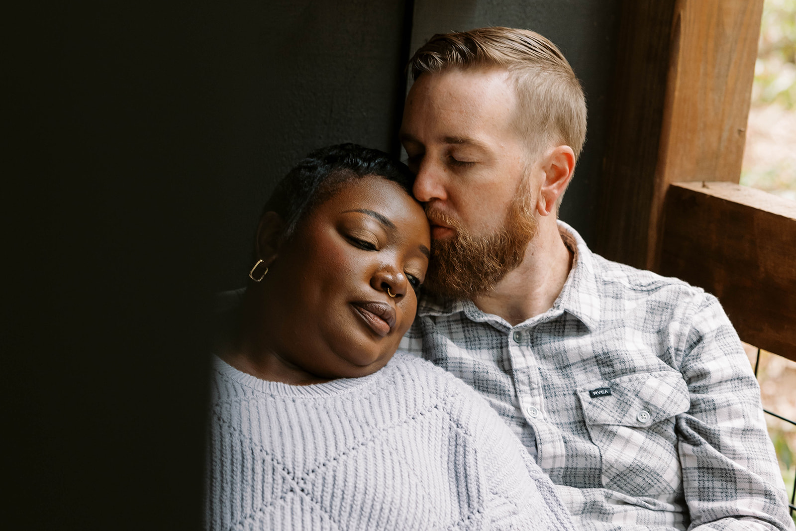 Man kissing woman during cabin photoshoot