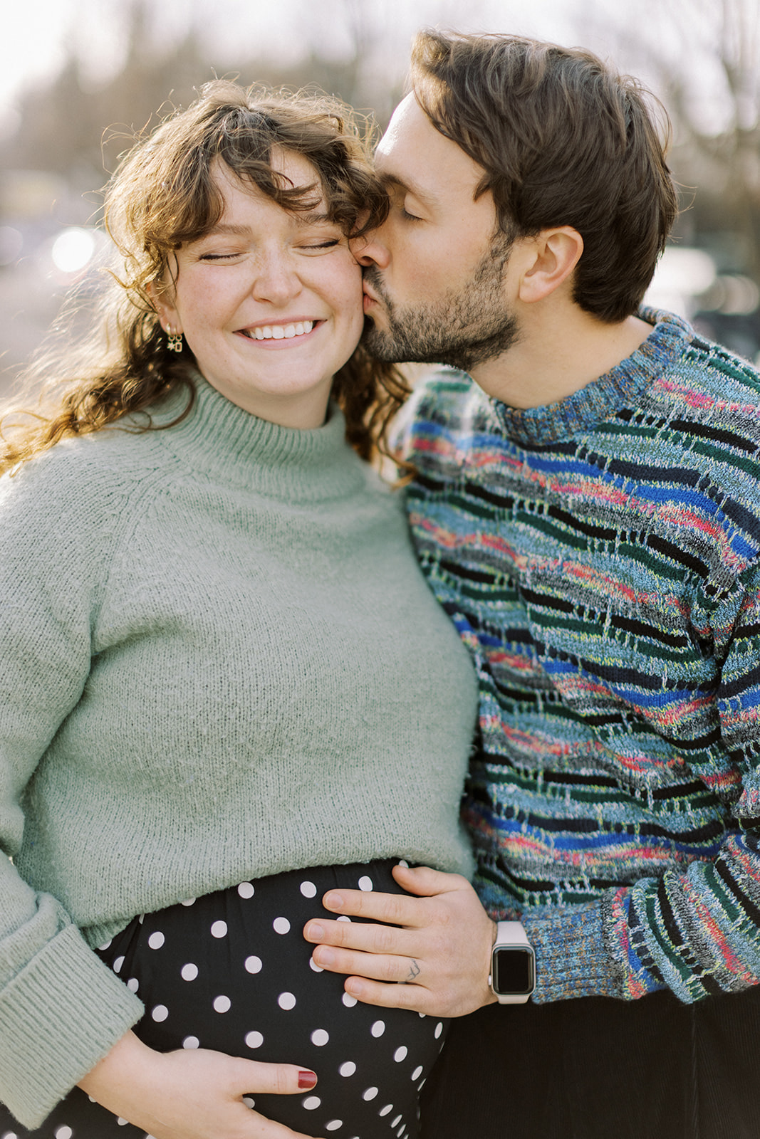 Cheerful couple during a Downtown maternity session in Perry District in Spokane, Washington.