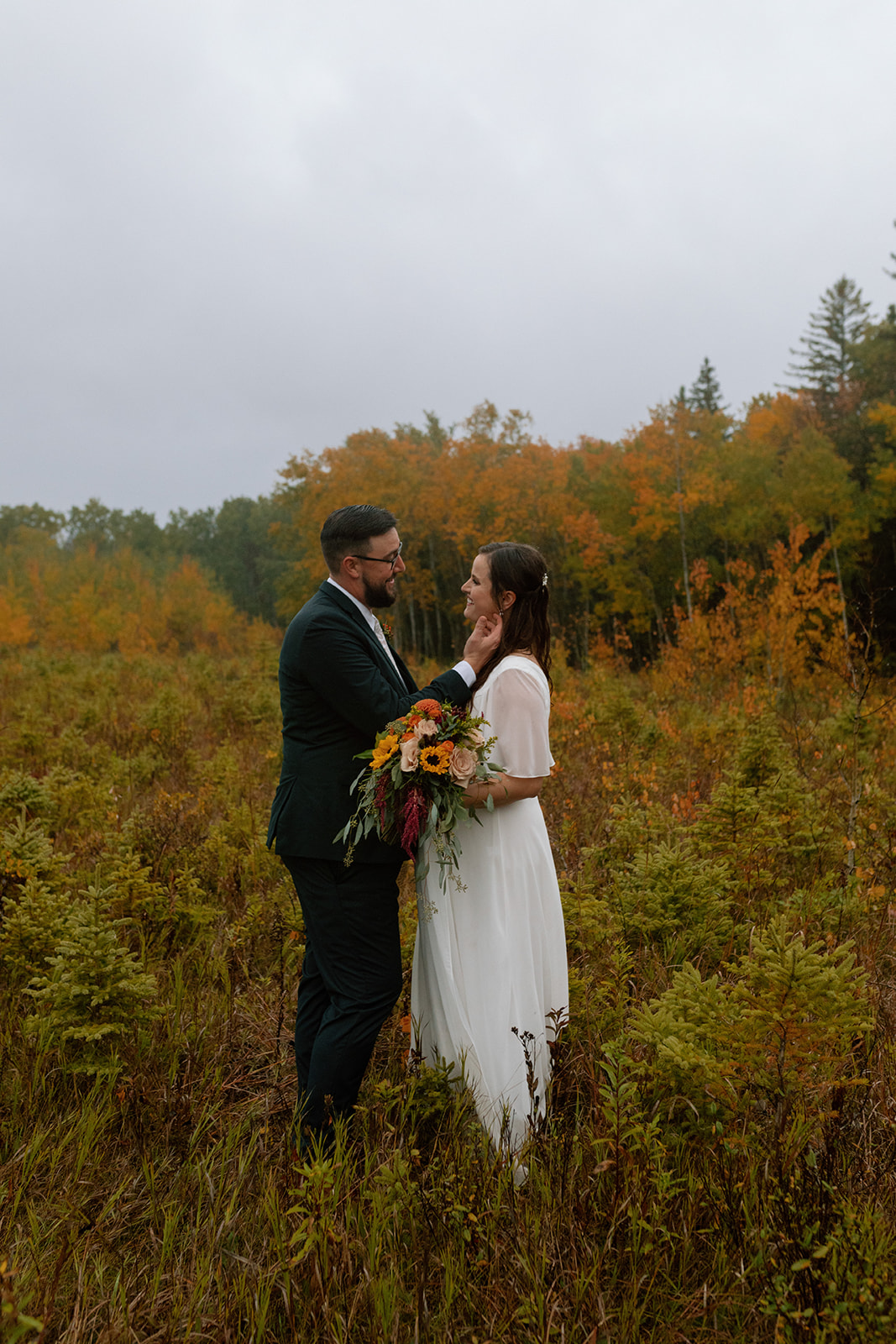 A couple who eloped in the autumn rain in Birds Hill Provincial Park, Manitoba