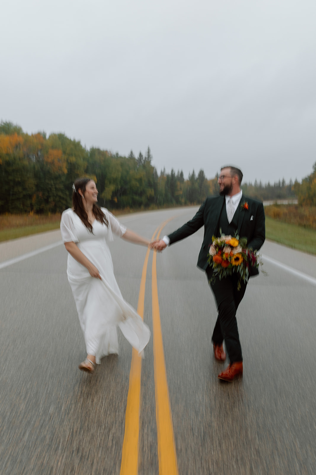 A couple who eloped in the autumn rain in Birds Hill Provincial Park, Manitoba